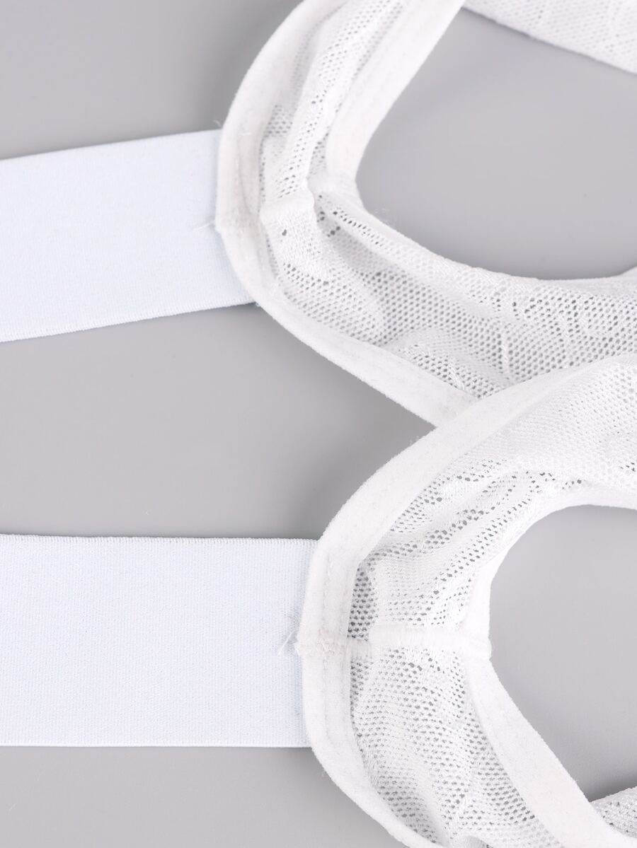 Men's white lace thong bodysuit with a low rise waist in medium stretch knitted fabric.